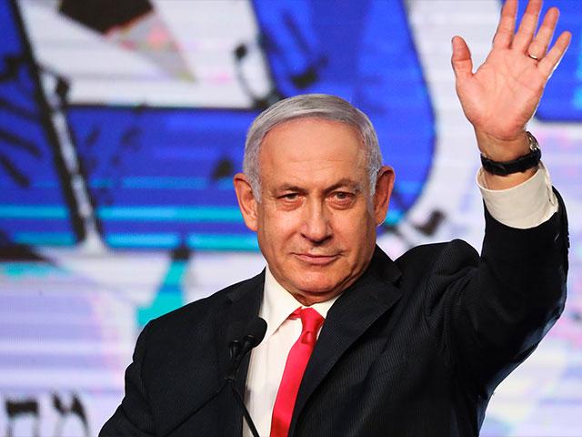 Israeli Prime Minister Benjamin Netanyahu waves to his supporters after the first exit poll results for the Israeli parliamentary elections at his Likud party&#039;s headquarters in Jerusalem, Wednesday, March. 24, 2021. (AP Photo/Ariel Schalit)