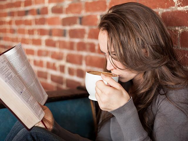 woman sipping coffee and reading a Bible