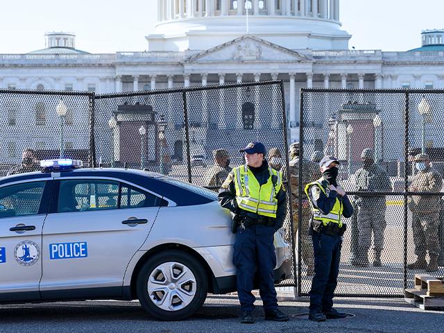 Fencing is placed around the exterior of the Capitol grounds, Jan. 7, 2021 after rioters stormed the Capitol. (AP Photo/John Minchillo)