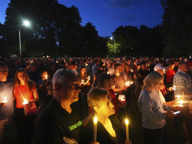 Attendees pay their respects during a vigil for Charlie Kirk on Friday, Sept. 12, 2025, in Provo, Utah. (AP Photo/Lindsey Wasson)