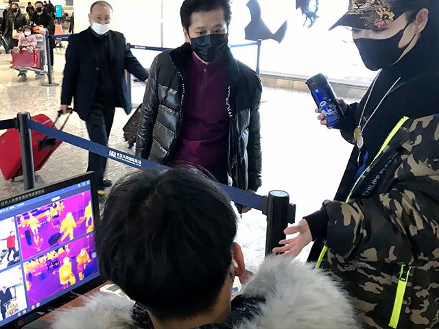 Travelers pass through a health screening checkpoint at Wuhan Tianhe International Airport in Wuhan in southern China&#039;s Hubei province, Tuesday, Jan. 21, 2020. (AP Photo/Emily Wang)