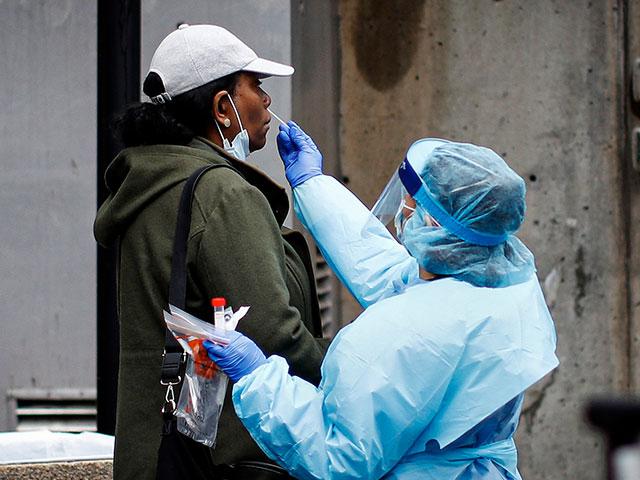 A patient is given a COVID-19 test by a medical worker outside Brooklyn Hospital Center (AP Photo)