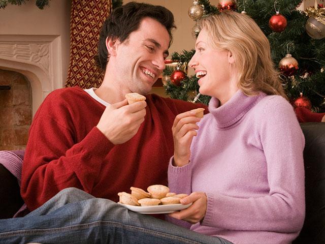 Couple eating Christmas cookies