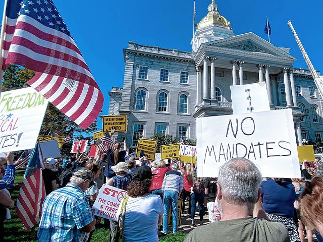 Demonstrators rally against vaccine mandates outside the Statehouse in Concord, N.H. (Geoff Forester/The Concord Monitor via AP)