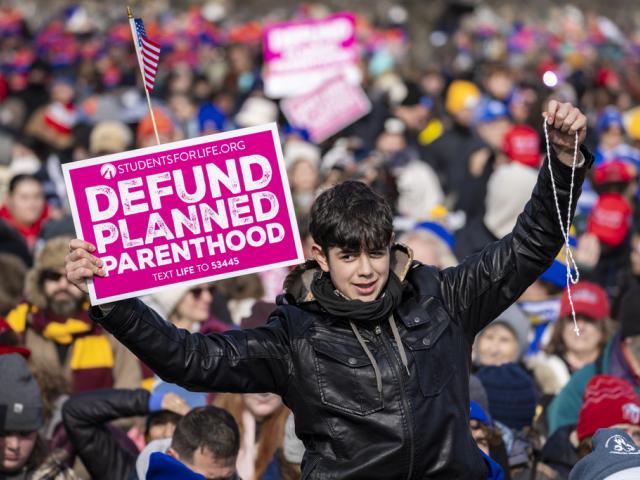 Young protestor raises a &quot;Defund Planned Parenthood&quot; sign during the 52nd annual March for Life on the National Mall in Washington on Jan. 24, 2025. (Angelina Katsanis/POLITICO via AP Images)