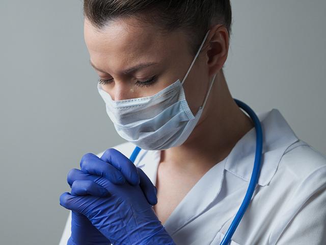 doctor praying and crying