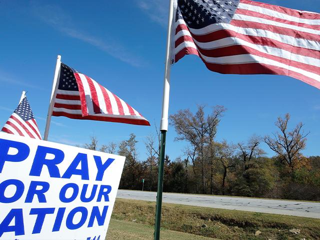 American flags fly over a sign reading &#039;Pray For Our Nation&#039; on Highway 27 Friday, Nov. 6, 2020, in Rome, Ga. (AP Photo/Ben Margot)