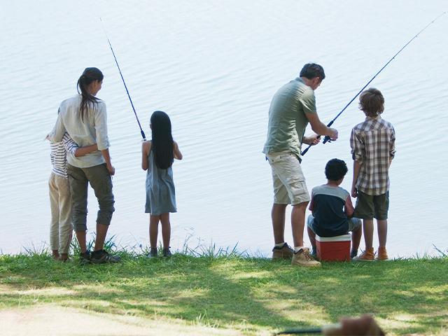 family fishing at a lake
