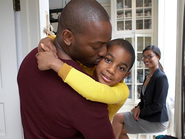 Father kissing son