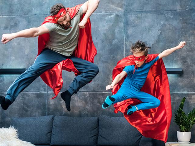 father and son with hero capes
