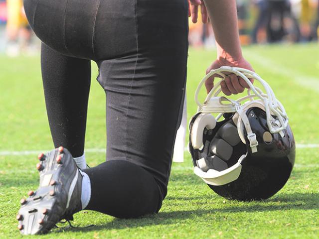 football player kneeling