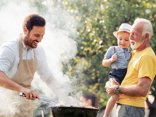three generations men grilling