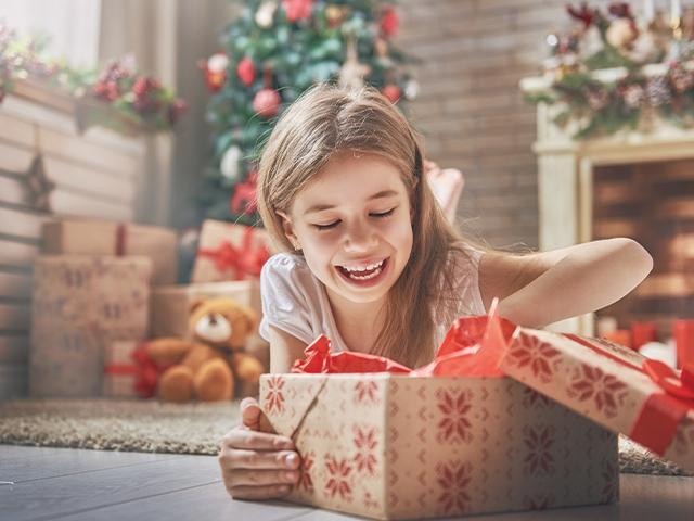 happy girl opening christmas present