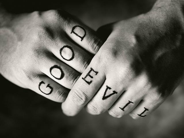 two hands with good written on one and evil on the other