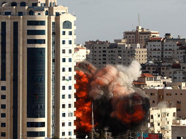 An Israeli air strike hits a building in Gaza City, Monday, May 17, 2021. (AP Photo/Hatem Moussa)