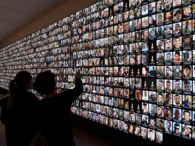 Photos of Israeli people who were murdered by Hamas terrorists on Oct. 7, displayed on a giant screen at the National Library in Jerusalem, Israel, Jan. 28, 2024. (AP Photo/Leo Correa)