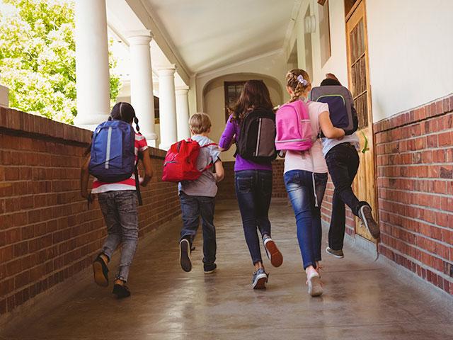 Kids running down school hallways