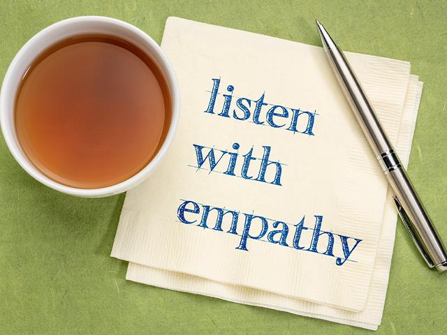 Listen with empathy written on a cocktail napkin