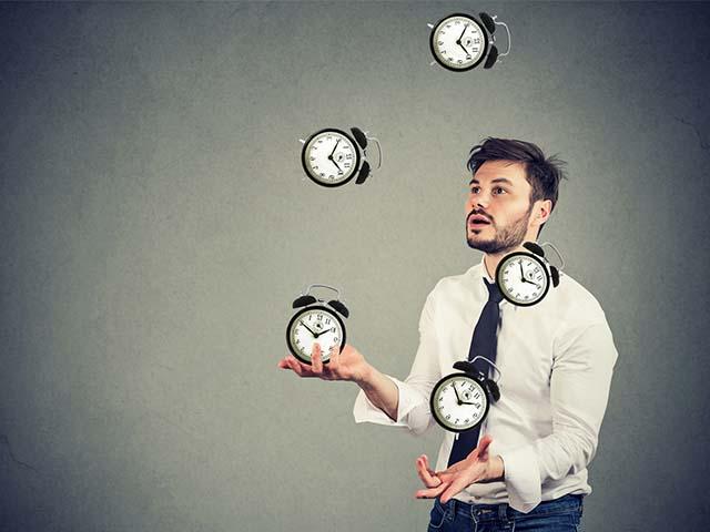 man juggling clocks