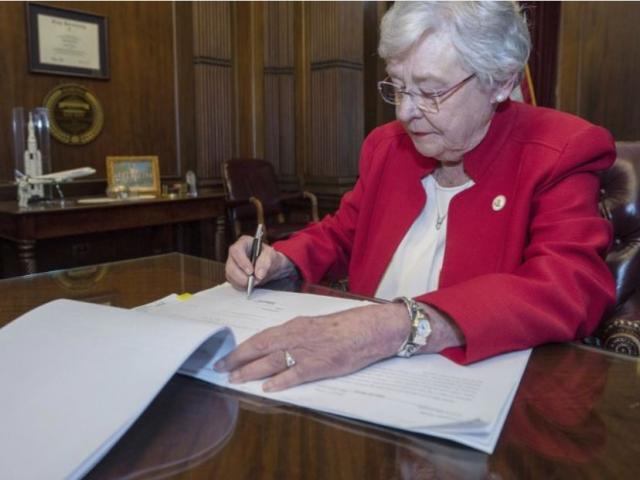 This photograph released by the state shows Alabama Gov. Kay Ivey signing a bill that virtually outlaws abortion in the state on Wednesday, May 15, 2019, in Montgomery, Ala. (Hal Yeager/Alabama Governor&#039;s Office via AP) 