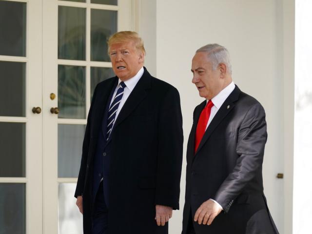 President Donald Trump and Israeli Prime Minister Benjamin Netanyahu walk to a meeting in the Oval Office of the White House, Monday, Jan. 27, 2020, in Washington. (AP Photo/ Evan Vucci)