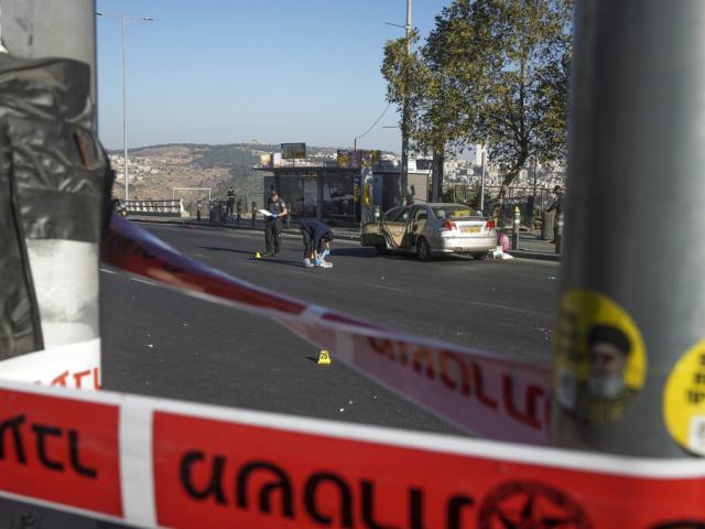 Israeli police inspect the scene of an explosion at a bus stop in Jerusalem. Wednesday, Nov. 23, 2022. At least a dozen were injured. Police suspect terrorism.  (AP Photo/Maya Alleruzzo)