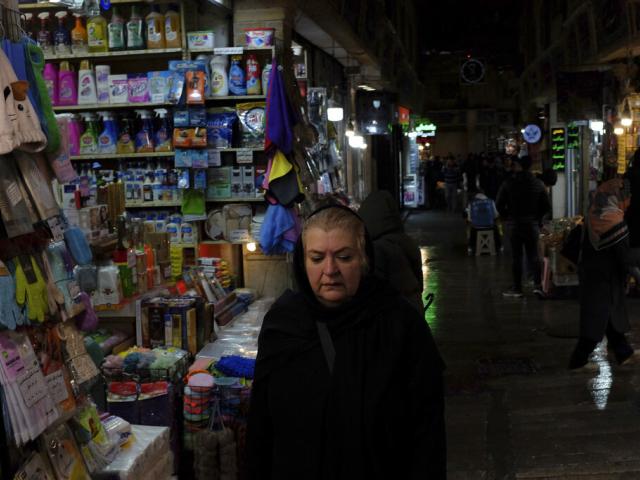 A woman walks through Tajrish bazaar in northern Tehran, Iran, Monday, Dec. 5, 2022. Confusion over the status of Iran’s religious police grew as state media cast doubt on reports the force had been shut down. (AP Photo/Vahid Salemi)