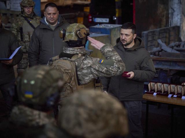 Ukrainian President Volodymyr Zelenskyy, right, awards a serviceman at the site of the heaviest battles with the Russian invaders in Bakhmut, Ukraine, Tuesday, Dec. 20, 2022. (Ukrainian Presidential Press Office via AP)
