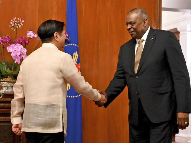 U.S. Secretary of Defense Lloyd James Austin III, right, shakes hands with Philippine President Ferdinand Marcos Jr. during a courtesy call at the Malacanang Palace in Manila, Philippines on Thursday, Feb. 2, 2023. (Jam Sta Rosa/Pool Photo via AP)