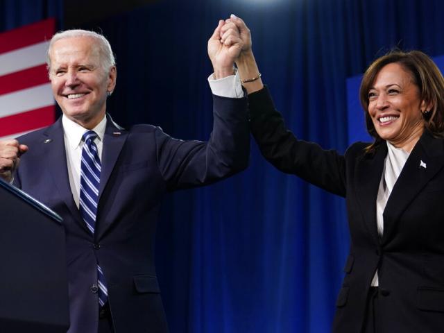 President Joe Biden and Vice President Kamala Harris stand on stage at the Democratic National Committee winter meeting, Feb. 3, 2023, in Philadelphia. (AP Photo/Patrick Semansky)