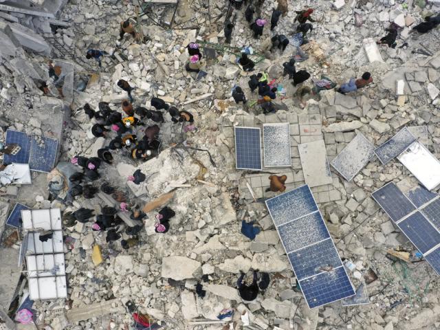 Civil defense workers and residents search through the rubble of collapsed buildings in the town of Harem near the Turkish border, Idlib province, Syria, Monday, Feb. 6, 2023. (AP Photo/Ghaith Alsayed)