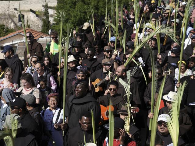 Christians walk in the Palm Sunday procession on the Mount of Olives in east Jerusalem, Sunday, April 2, 2023. (AP Photo/Mahmoud Illean)
