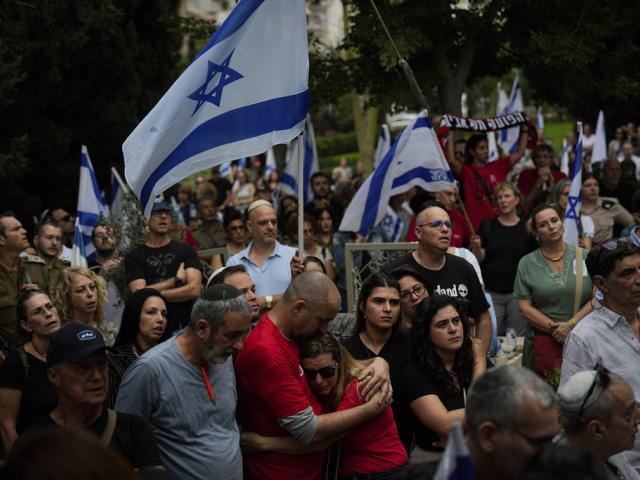 Mourners attend the funeral of Sgt. Roni Eshel in Kfar Saba, Israel, Sunday Nov. 12, 2023.  (AP Photo/Ariel Schalit)