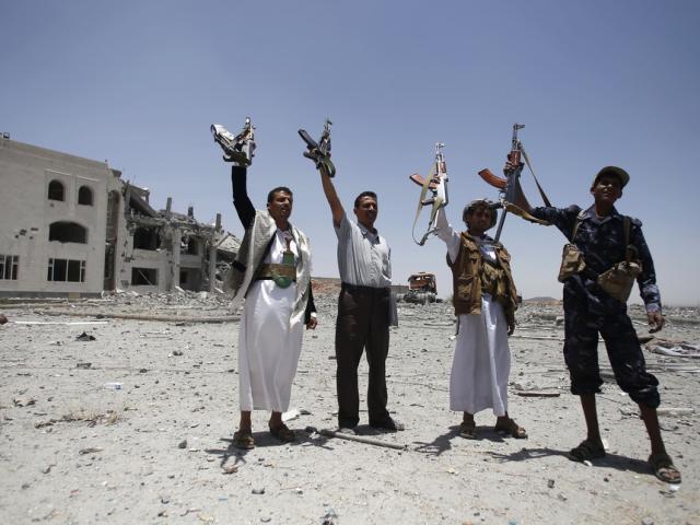Shiite fighters, known as Houthis, hold up their weapons as they chant slogans in Sanaa, Yemen, April 28, 2015. (AP Photo/Hani Mohammed, File)
