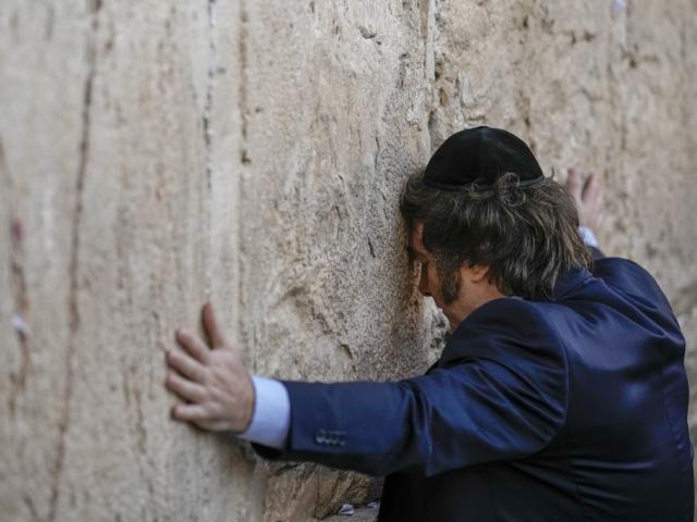 Argentine President Javier Milei touches the Western Wall, the holiest site where Jews can pray, in Jerusalem&#039;s Old City, Feb. 6, 2024. (AP Photo/Leo Correa)