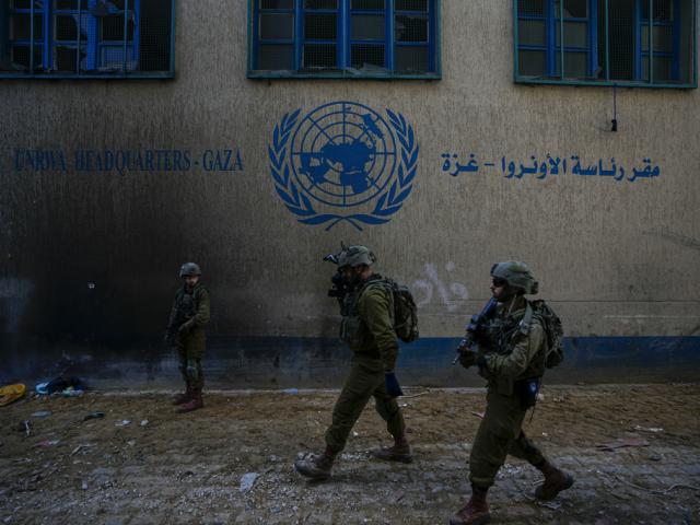 Israeli soldiers take position as they enter the UNRWA headquarters where the IDF discovered Hamas tunnels underneath the agency, Feb. 8, 2024. (AP Photo/Ariel Schalit)
