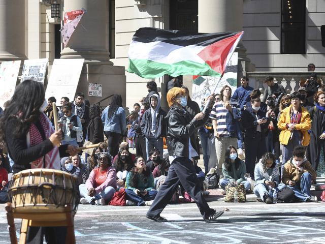 Several hundred students and pro-Palestinian supporters rally at the intersection of Grove and College Streets, in front of Woolsey Hall on the campus of Yale University in New Haven, Conn. April 22, 2024. (Ned Gerard/Hearst Connecticut Media via AP)