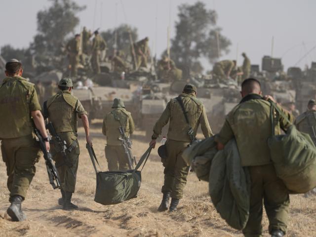 Israeli soldiers are seen at a staging ground near the border with the Gaza Strip, in southern Israel, Tuesday, April 30, 2024. (AP Photo/Tsafrir Abayov)