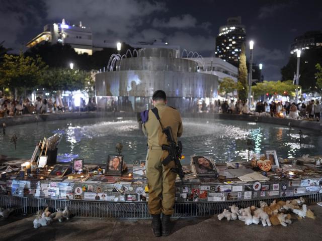 An Israeli soldier pays respect at a memorial for victims of the bloody Oct. 7, cross-border attack by Hamas on the eve of Israel&#039;s annual Memorial Day, in Tel Aviv, Israel, Sunday, May 12, 2024. (AP Photo/Oded Balilty)
