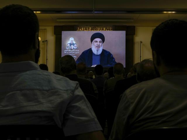 Hezbollah supporters watch a speech given by Hezbollah leader Sheikh Nasrallah on a screen in the southern Beirut suburb of Dahiyeh, Lebanon, Wednesday, June 19, 2024. (AP Photo/Bilal Hussein)