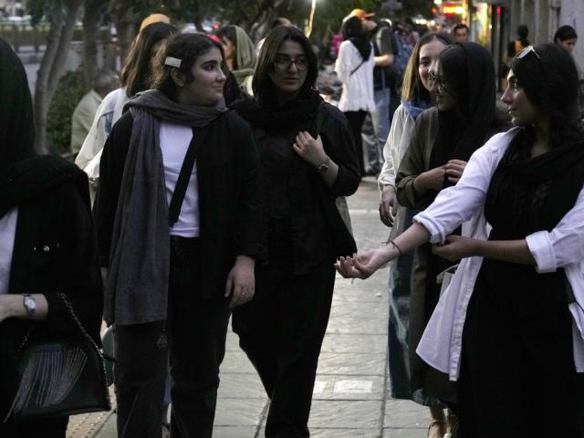 Iranian women without wearing their mandatory Islamic headscarf walk in downtown Tehran, Iran, Monday, June 10, 2024. (AP Photo/Vahid Salemi)