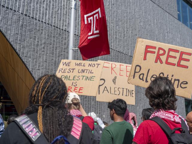 People hold up signs during a pro-Palestine rally and march on Temple University campus in Philadelphia, Aug. 29, 2024. (AP Photo/Chris Szagola)