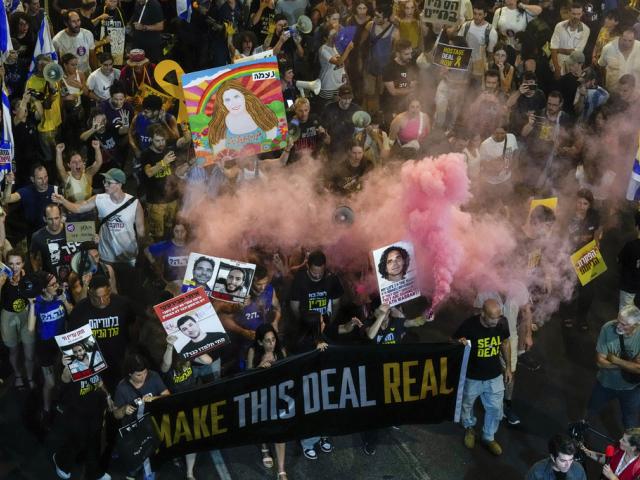 In this aerial image, people attend a rally demanding a cease-fire deal and the immediate release of hostages held by Hamas in the Gaza Strip in Tel Aviv, Israel on Wednesday, Sept. 4, 2024. (AP Photo/Ariel Schalit)