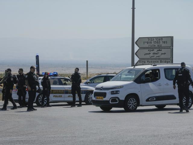 Israeli police stand guard near the site of a deadly shooting attack where Israeli officials say three people were shot and killed at the Allenby Bridge Crossing between the West Bank and Jordan, Sunday, Sept. 8, 2024. (AP Photo/Mahmoud Illean)