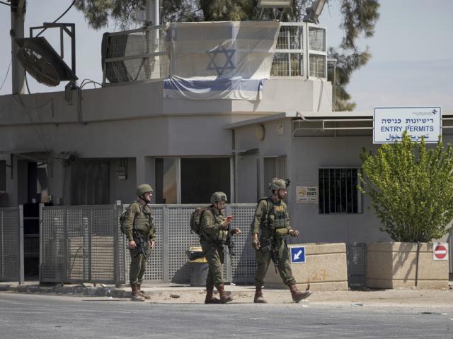 Israeli soldiers stand guard near the site of a deadly shooting attack where Israeli officials say three people were shot and killed at the Allenby Bridge Crossing between the West Bank and Jordan, Sunday, Sept. 8, 2024. (AP Photo/Mahmoud Illean)