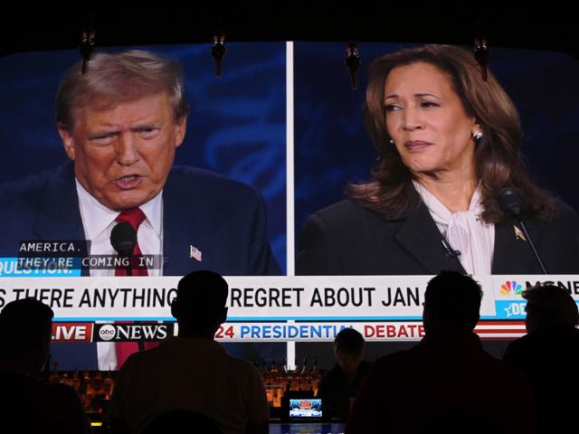 People watch the presidential debate between Former President Donald Trump and Vice President Kamala Harris, Tuesday, Sept. 10, 2024, at the Gipsy Las Vegas in Las Vegas. (AP Photo/John Locher)