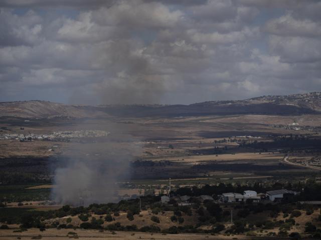 Smoke rises to the sky as fire burns in an area, following an attack from Lebanon, near the Kibbutz Snir, as seen from the Israeli Golan Heights, Monday, Sept. 16, 2024. (AP Photo/Leo Correa)