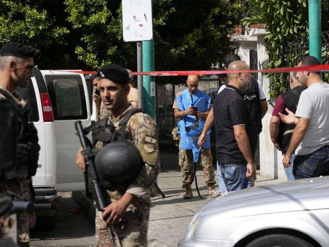 Police tape cordons off the area as security members and an explosive specialist investigate a suspicious device in Beirut, Thursday, Sept. 19, 2024. (AP Photo/Hassan Ammar)