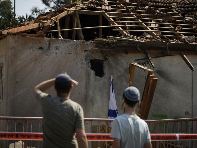 People look at a damaged house that was hit by a rocket fired from Lebanon, near Safed, northern Israel, on Wednesday, Sept. 25, 2024. (AP Photo//Leo Correa)