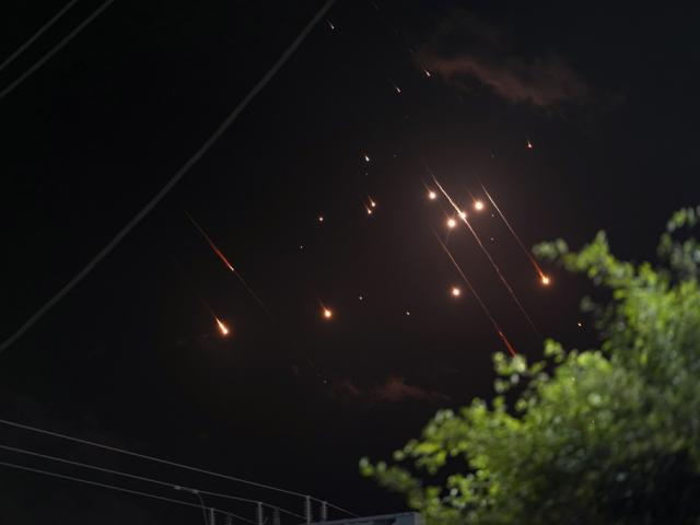 Missiles launched from Iran towards Israel streak across the night sky as seen from Deir al-Balah, Gaza Strip, Tuesday, Oct. 1, 2024. (AP Photo/Abdel Kareem Hana)